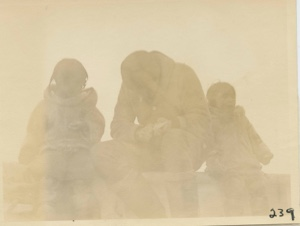 Image of Goddard with two Eskimo children, aboard